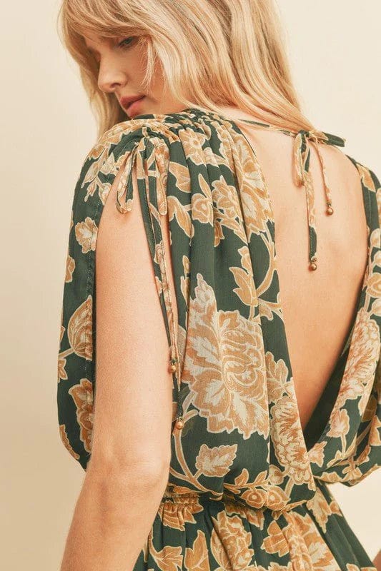 green and gold printed romper with open back and cinched sleeves